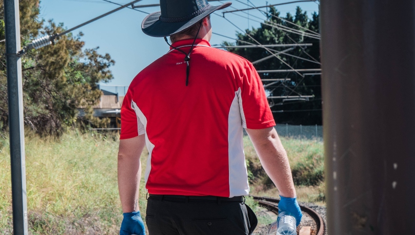 5 Benefits of Branded Workwear - man in red and white branded polo shirt work uniform