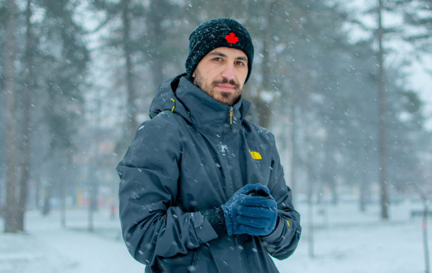 man in the snow wearing custom logo printed branded winter jacket